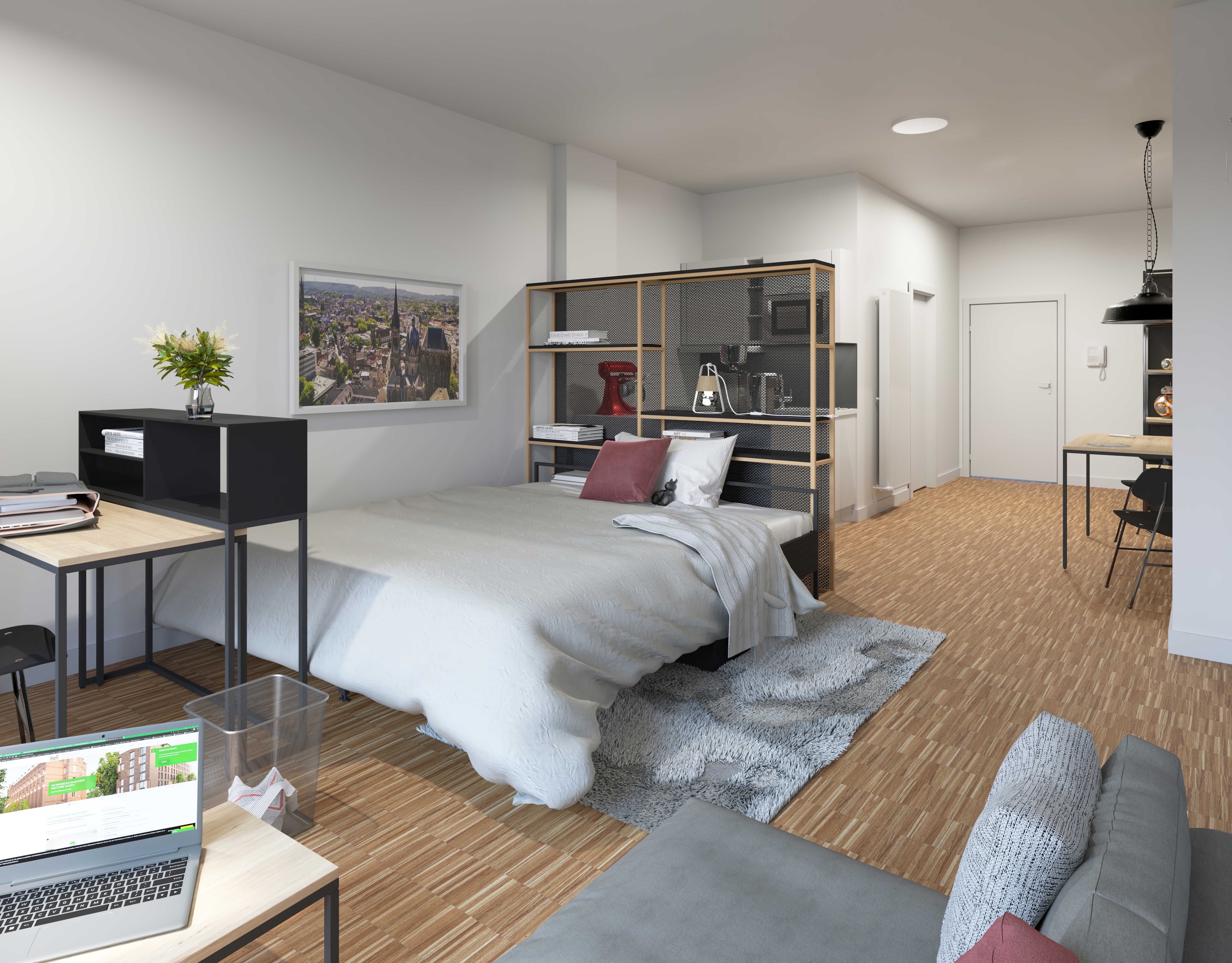 Helles Studio-Apartment mit integriertem Küchenbereich, gemütlichem Bett und Schreibtisch.