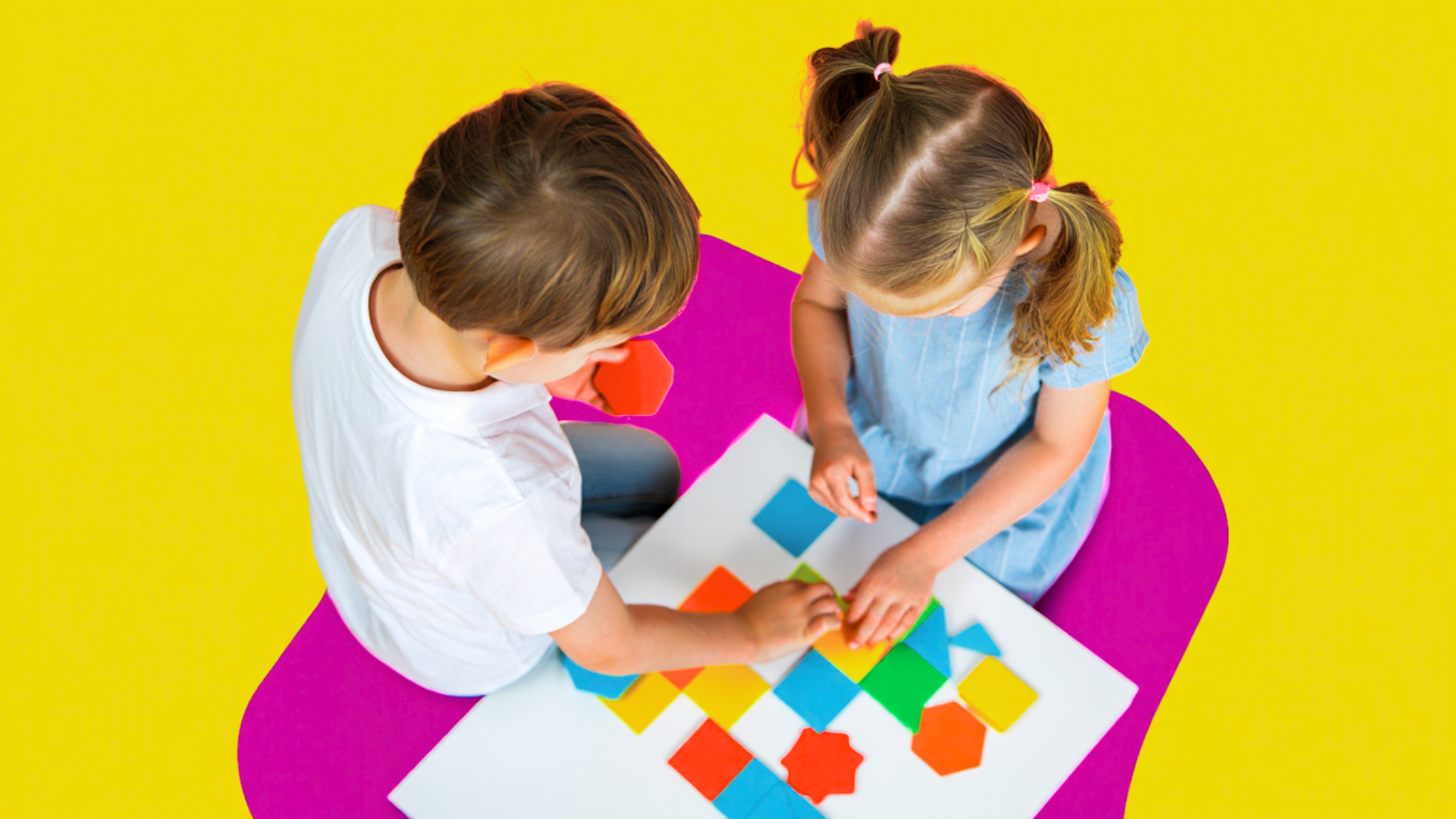 Elementary-aged kids working on a math project using shapes to make patterns