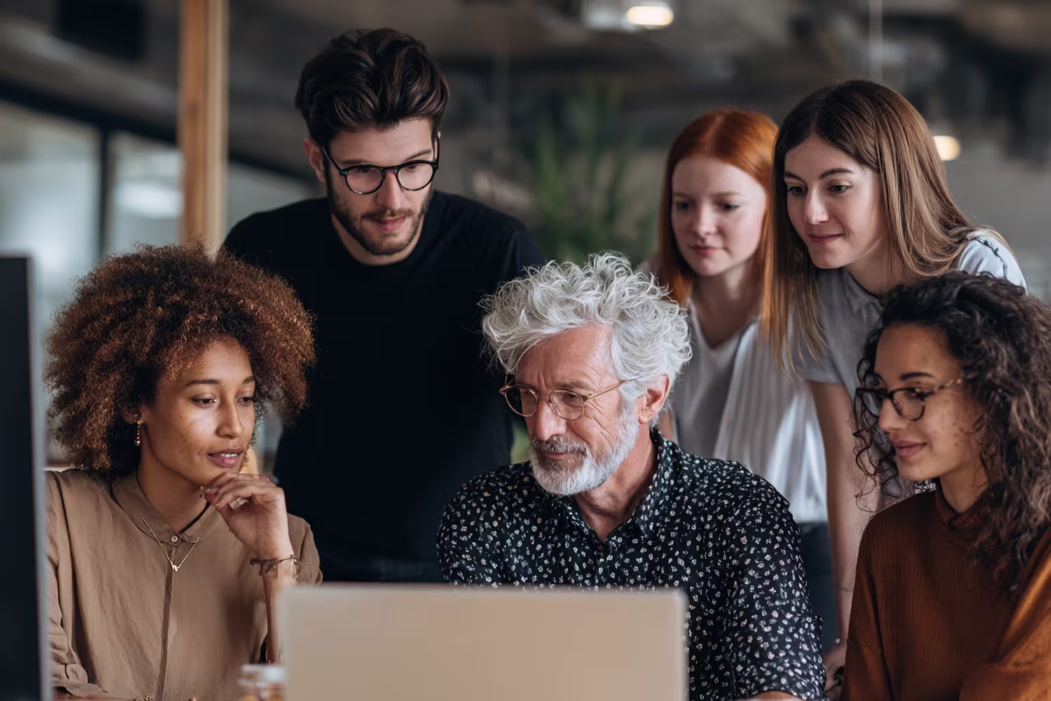 Diverse team collaborating on outsourced IT support