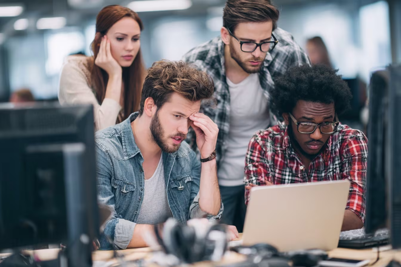 Multicultural employees troubleshooting common IT issues