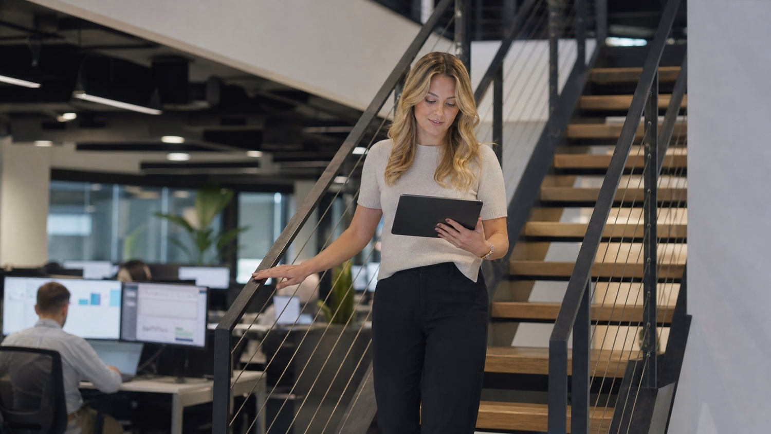 Woman descending stairs, reviewing tablet, AI insights 60 chars