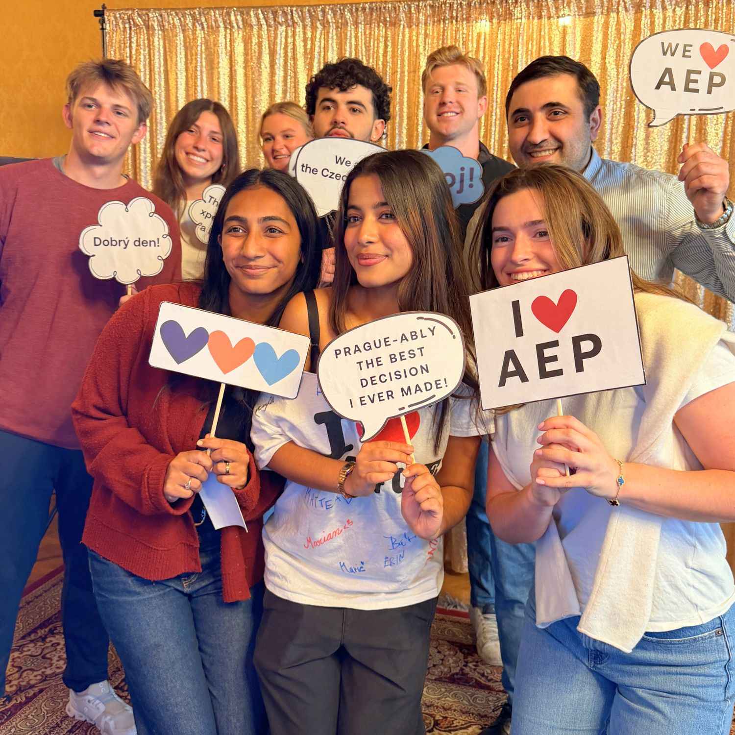 AEP students holding photo booth signs at a program event