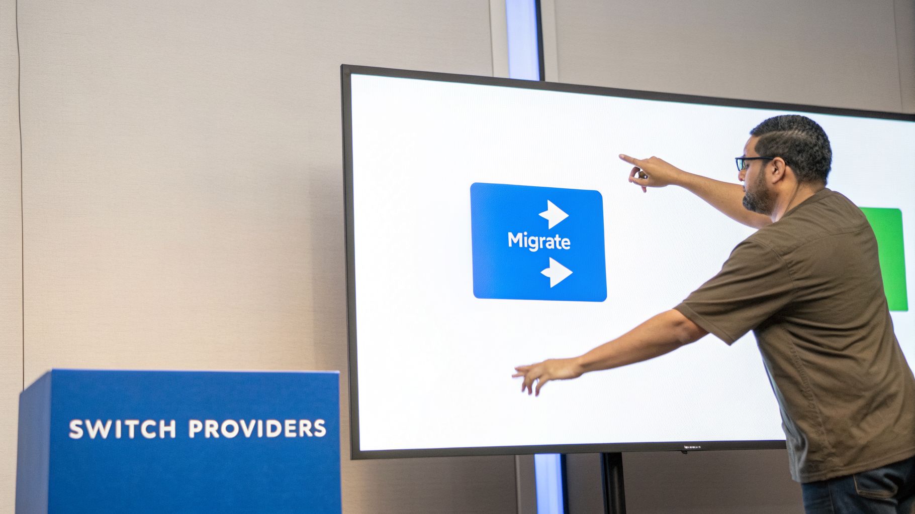 A man in glasses points at a large screen displaying a 'Migrate' button, with a 'SWITCH PROVIDERS' box.