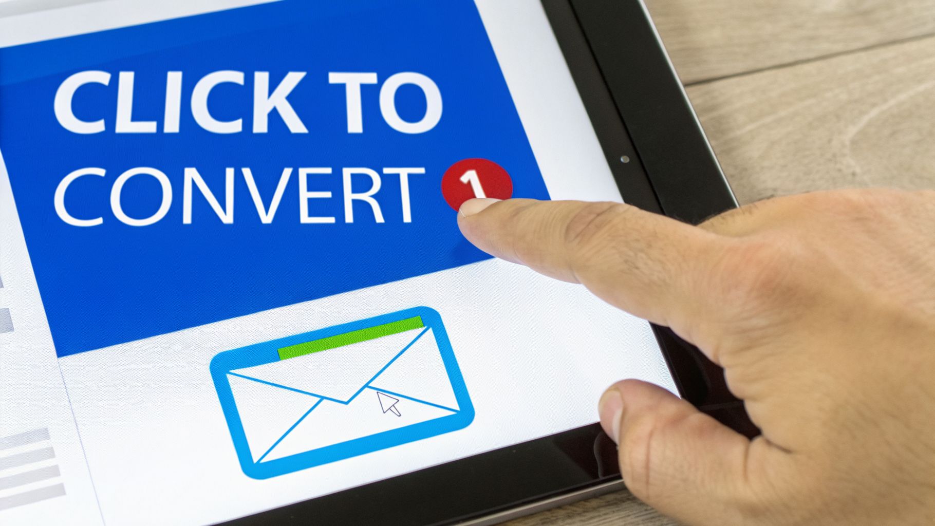 A finger touches a tablet screen displaying a 'CLICK TO CONVERT' banner and an email icon.