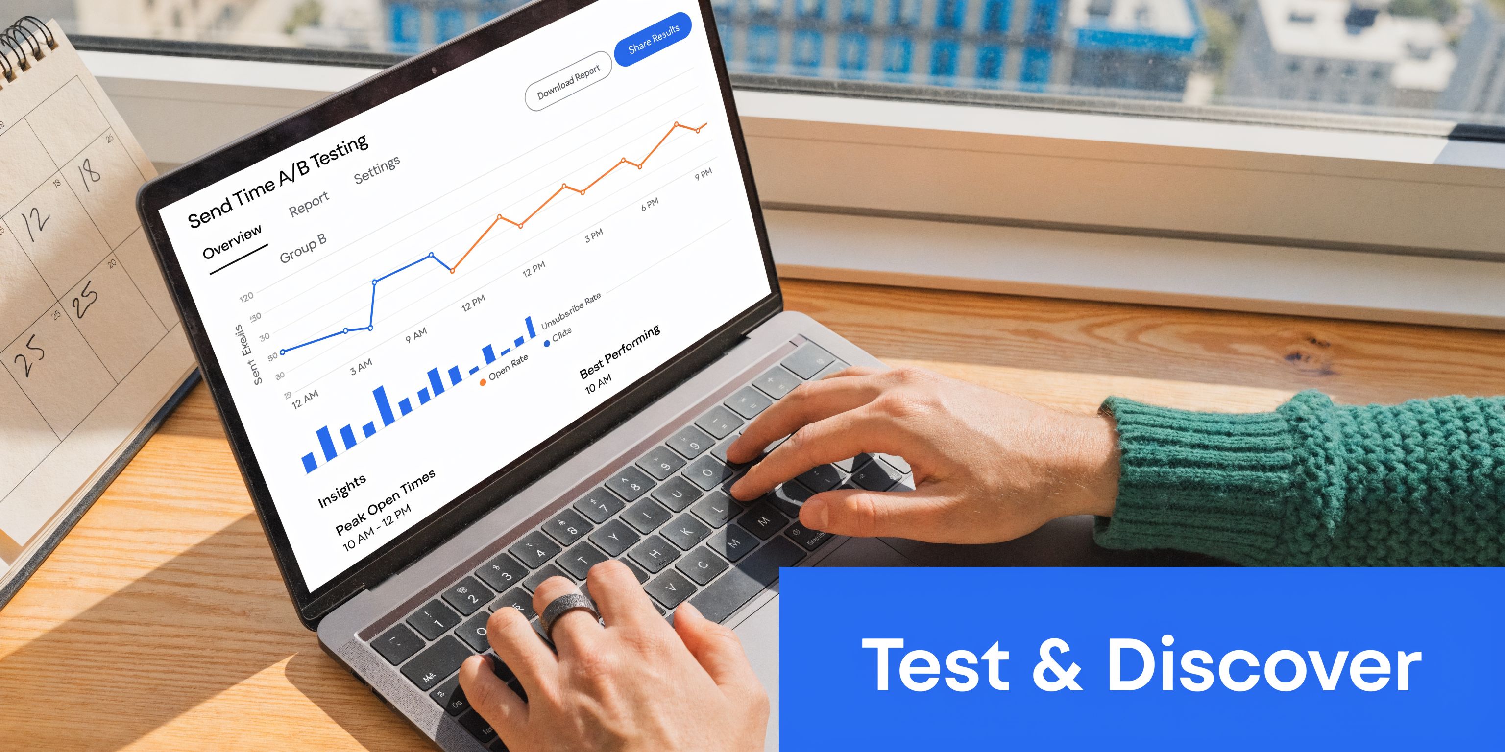 A person using a laptop to analyze email A/B testing data on a sunny desk with a calendar.