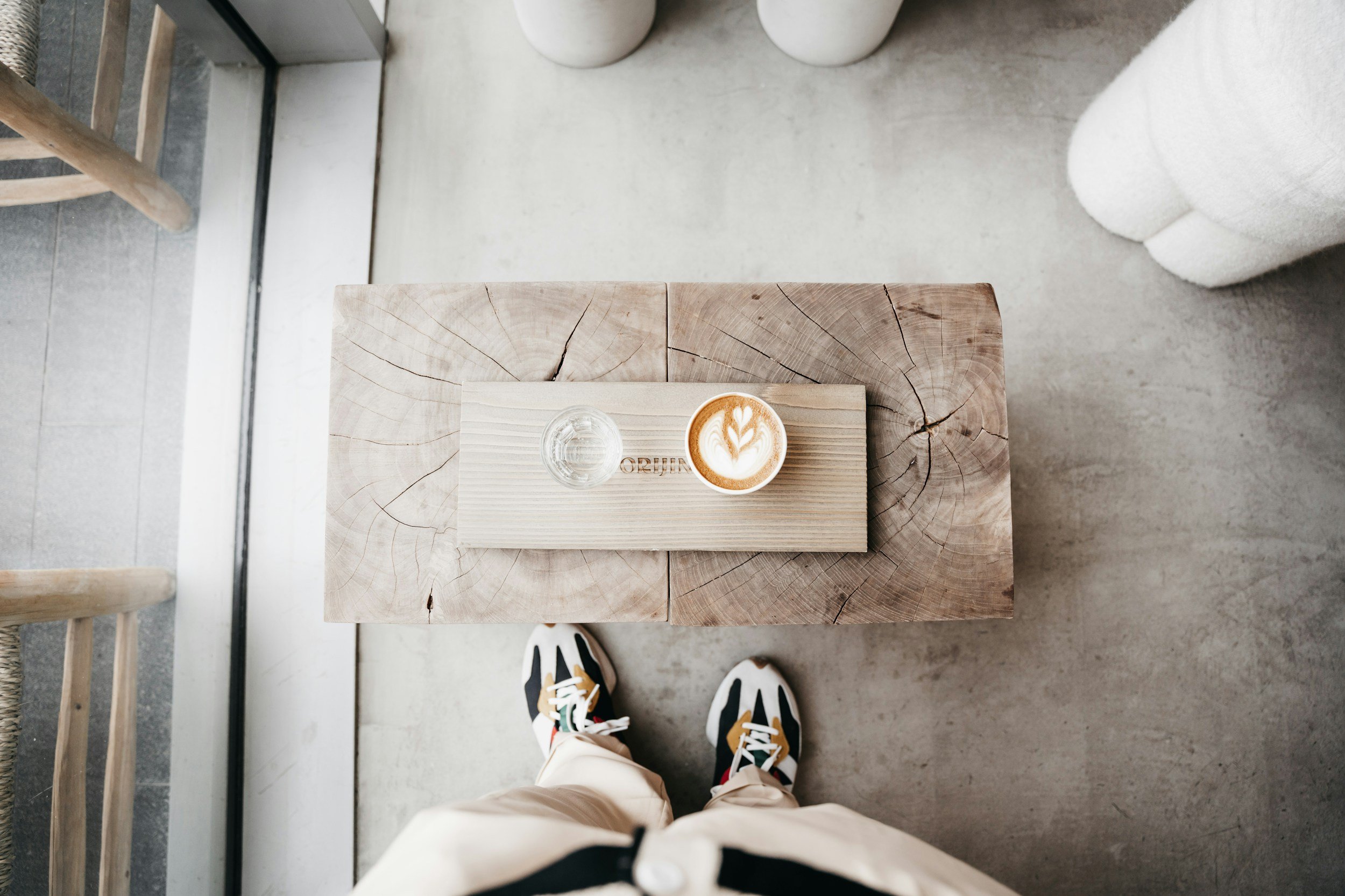 Manchester cafe scene with latte art on a rustic wood table, top-down view.