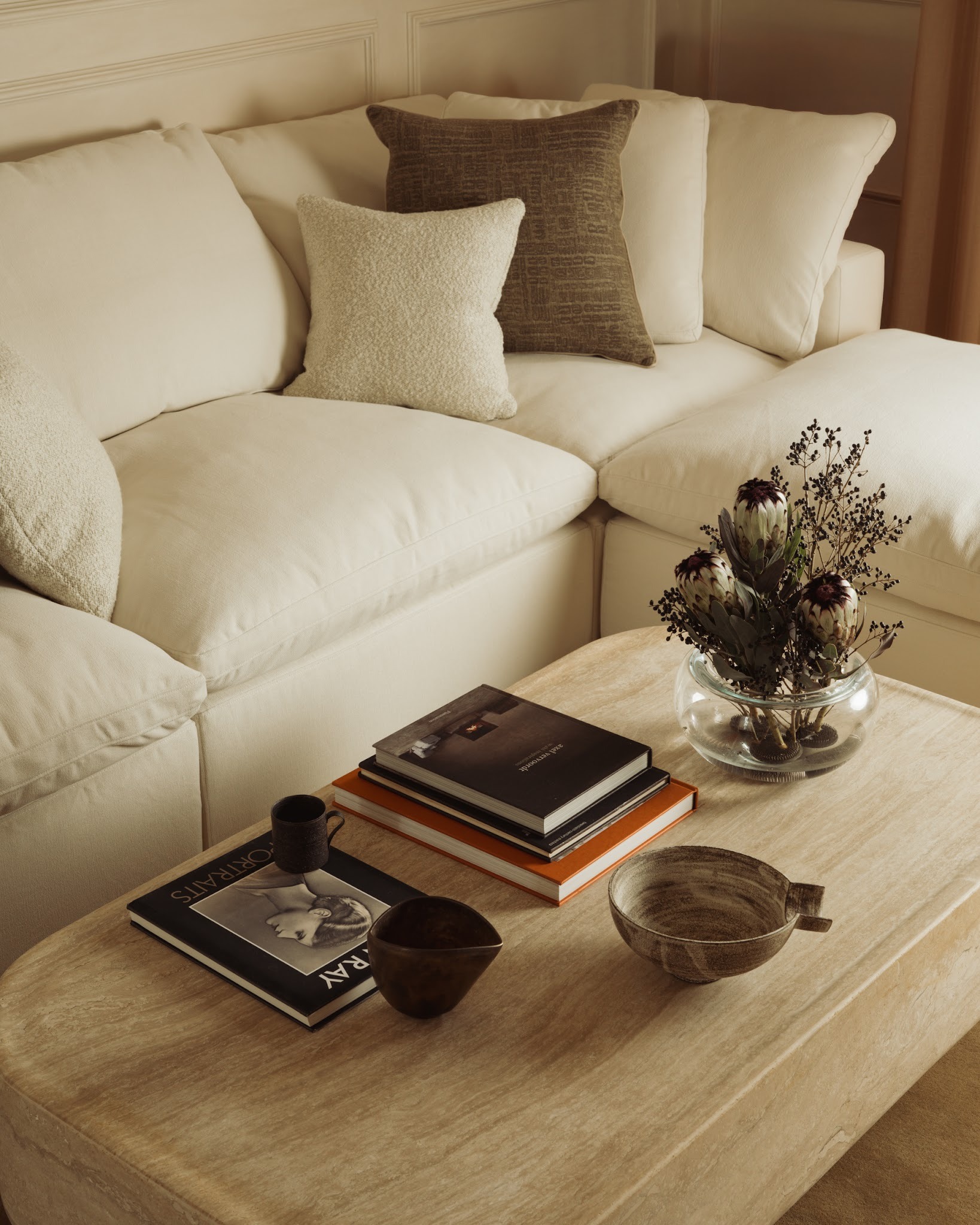 Layered living room with upholstered seating, curtains and textured soft furnishings in a London home