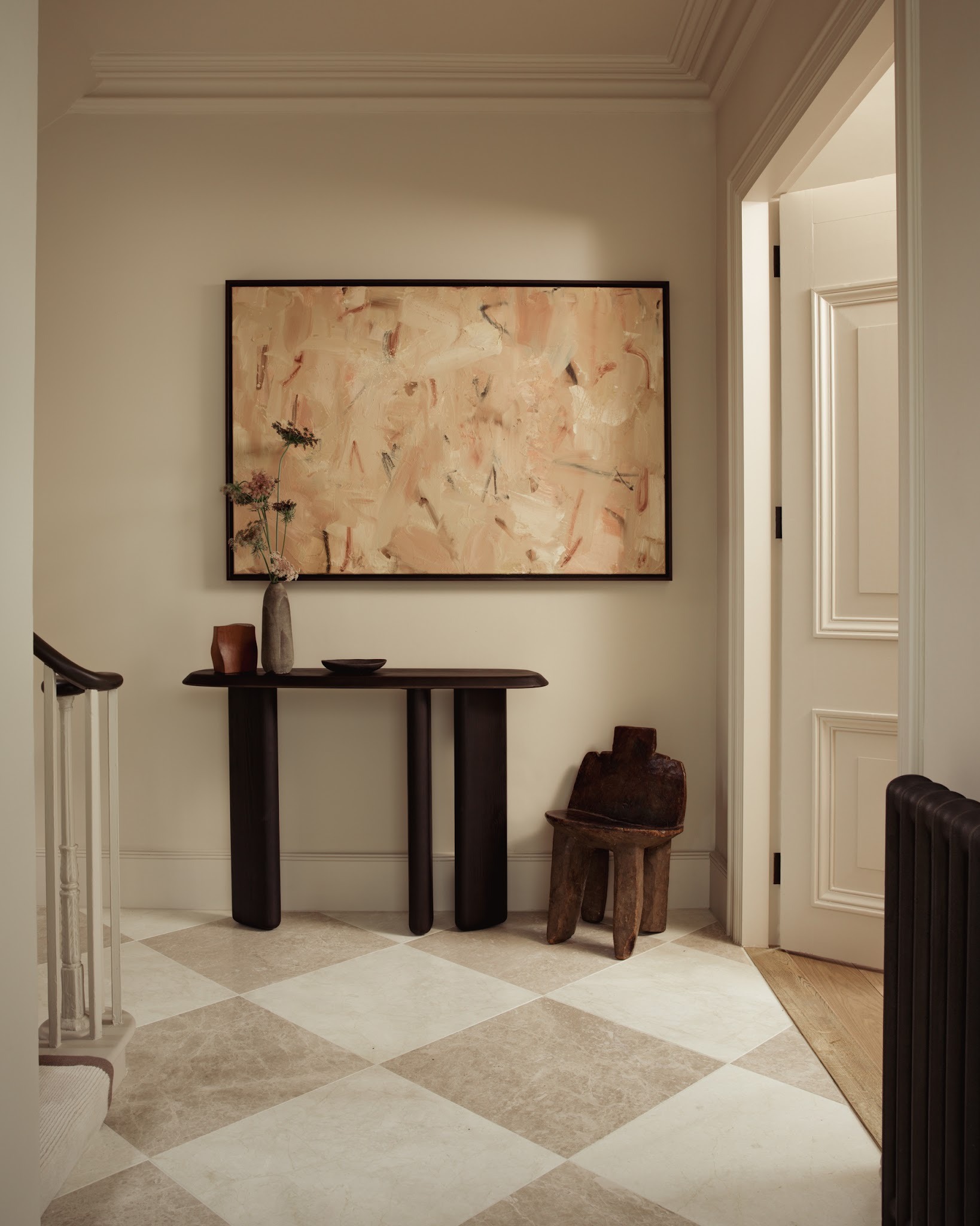 Panelled entrance hallway with console table and wall lights in a London period home