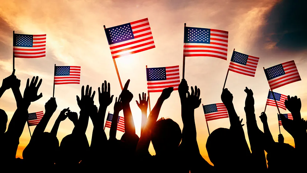 Some people raising the united states flag