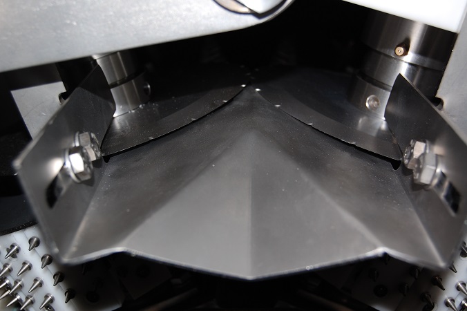 Close-up of scalping machine's stainless-steel cutting chamber.
