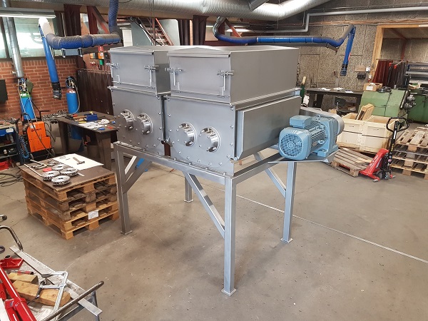 Single stainless steel horizontal mixer in seafood plant workshop.