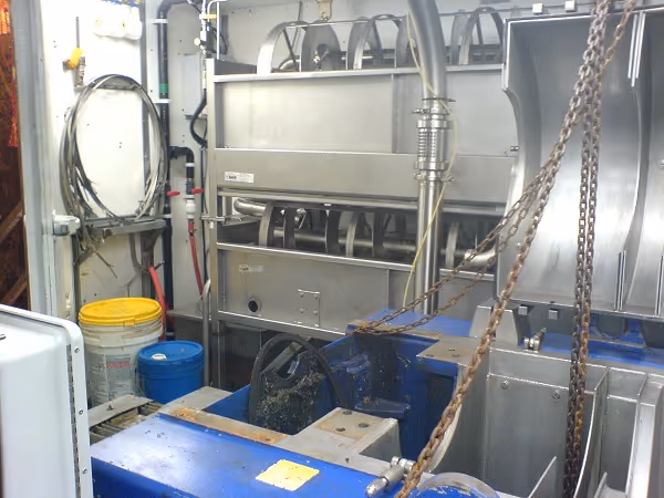 Rotary screen installed in seafood processing facility.