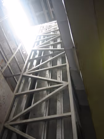 Tall vertical product elevator for lifting crates or fish blocks.