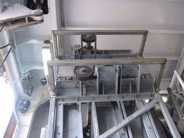 Upper section of stainless-steel product elevator system.