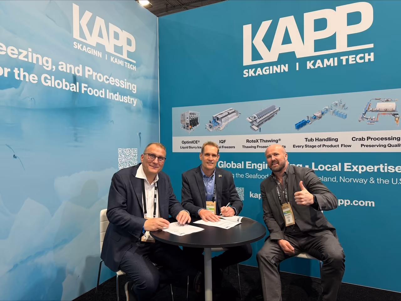 Heimir Halldórsson, Christo Du Plessis, and Árni Páll Einarsson signing the agreement at the KAPP booth at the Seafood Expo in Barcelona.