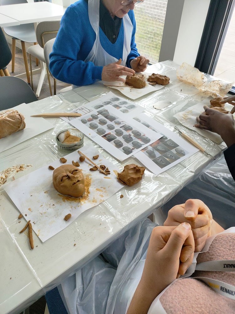 image of a tailor deep in thought while stitching