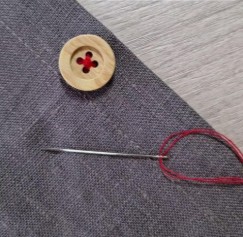 image of measuring tape and fabric on a table (for a tailors & alteration shop)