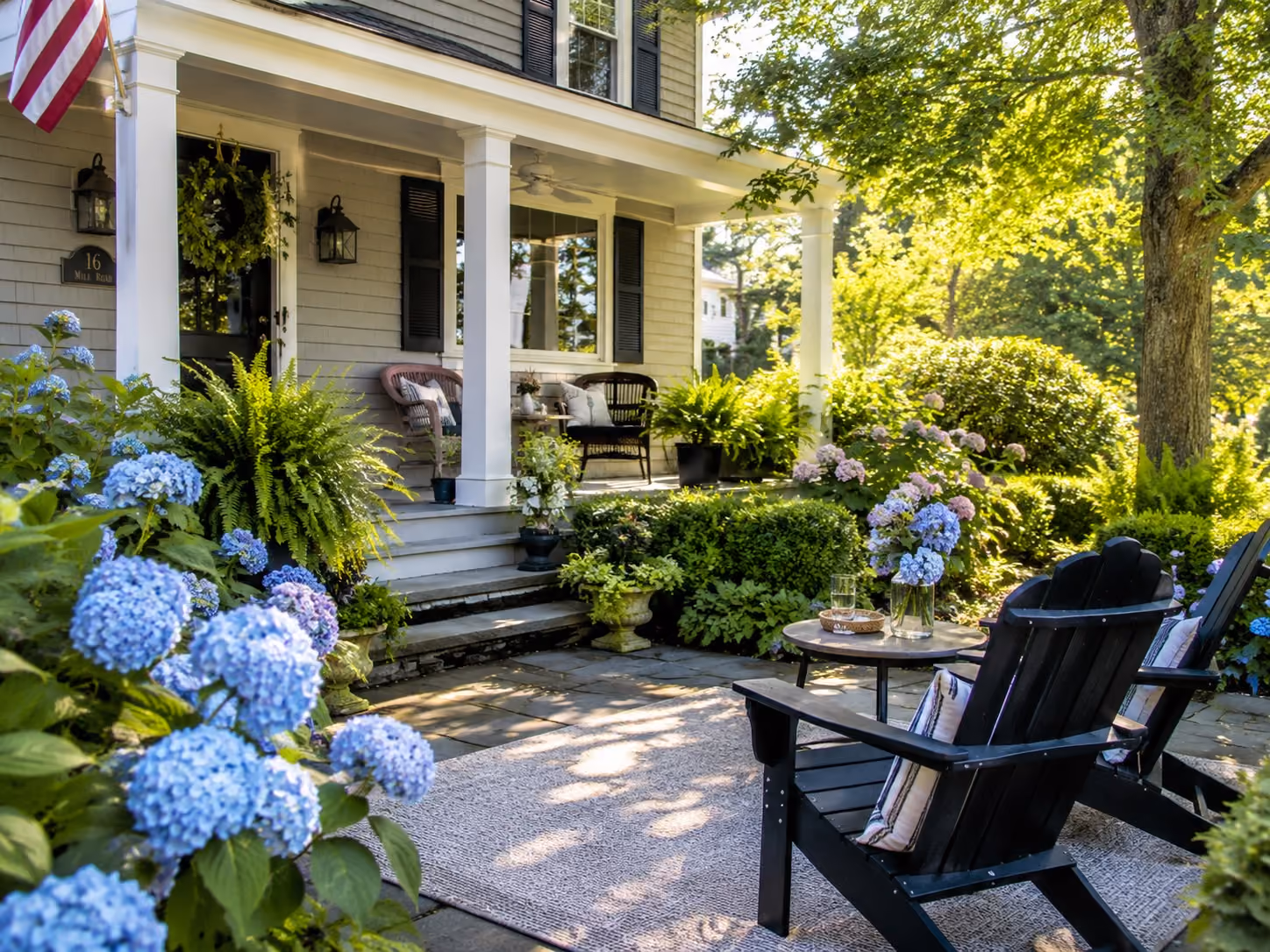 A family enjoying a summer evening in a well-maintained backyard with outdoor seating, string lights, and a garden, reflecting the lifestyle many homeowners enjoy across New Hampshire and Massachusetts.