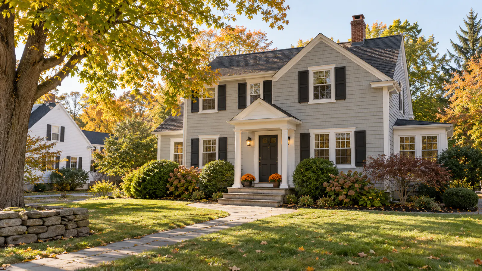 Well-maintained Manchester, New Hampshire home with tidy landscaping in early fall.