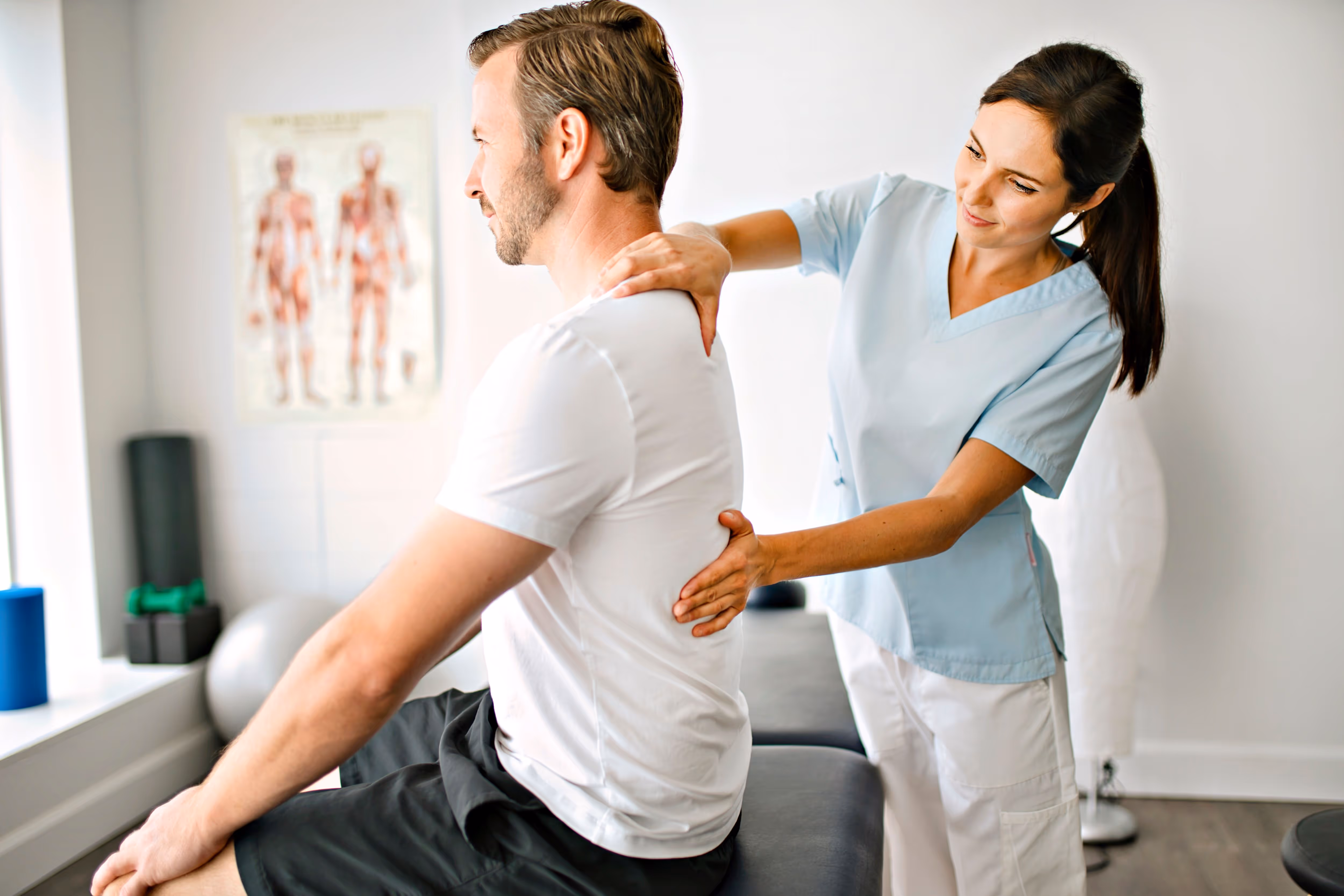 A woman sitting on a man's back in a room.