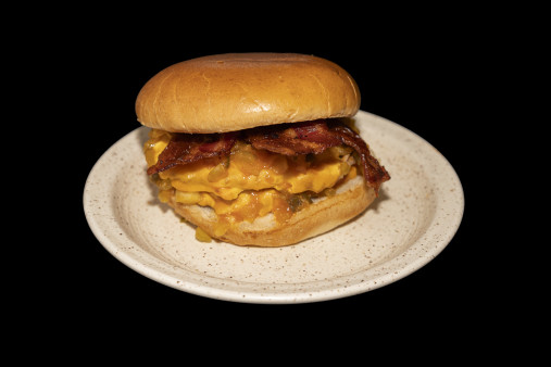 A close up of a burger with lettuce and tomato.