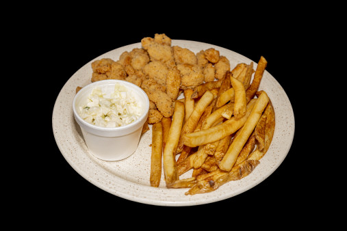 A basket of french fries with seasoning on top.