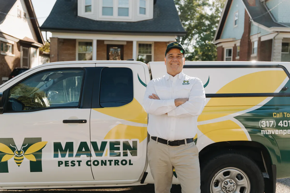 Maven Pest Control technician at work outside a home