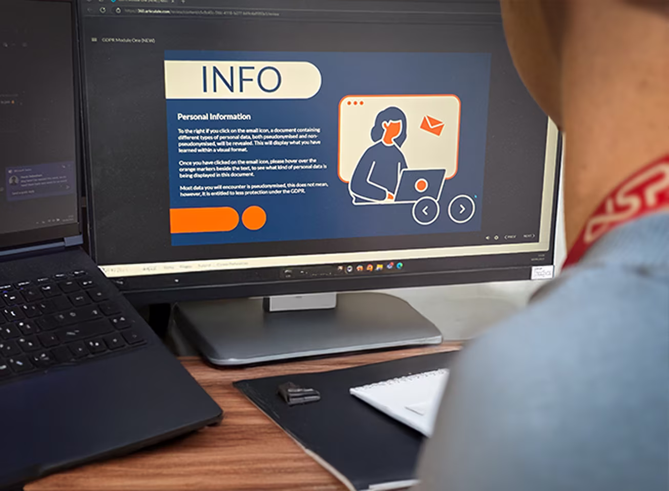 Alt-text: A man sits on a computer completing the USP College GDPR e-learning programme.