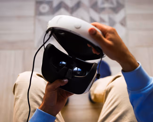 A headset being prepared to be worn from the first person perspective.