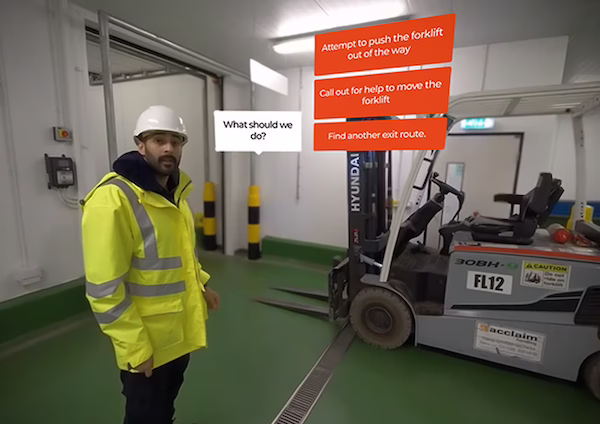 A still from the Thames Freeport emergency evacuation VR simulation training, with a worker in hi-vis and a safety helmet and a forklift in the background.