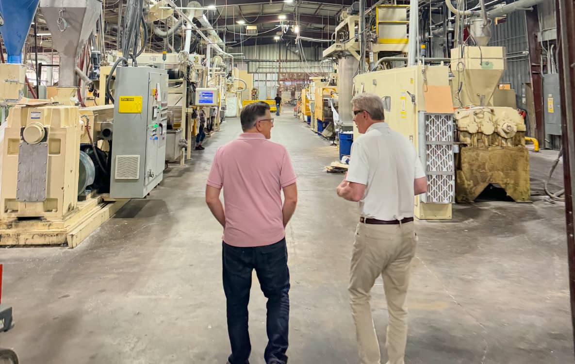 Spiro CEO touring a customer’s manufacturing plant with the client’s CEO, highlighting Spiro’s personalized CRM setup and ERP integration for manufacturers.