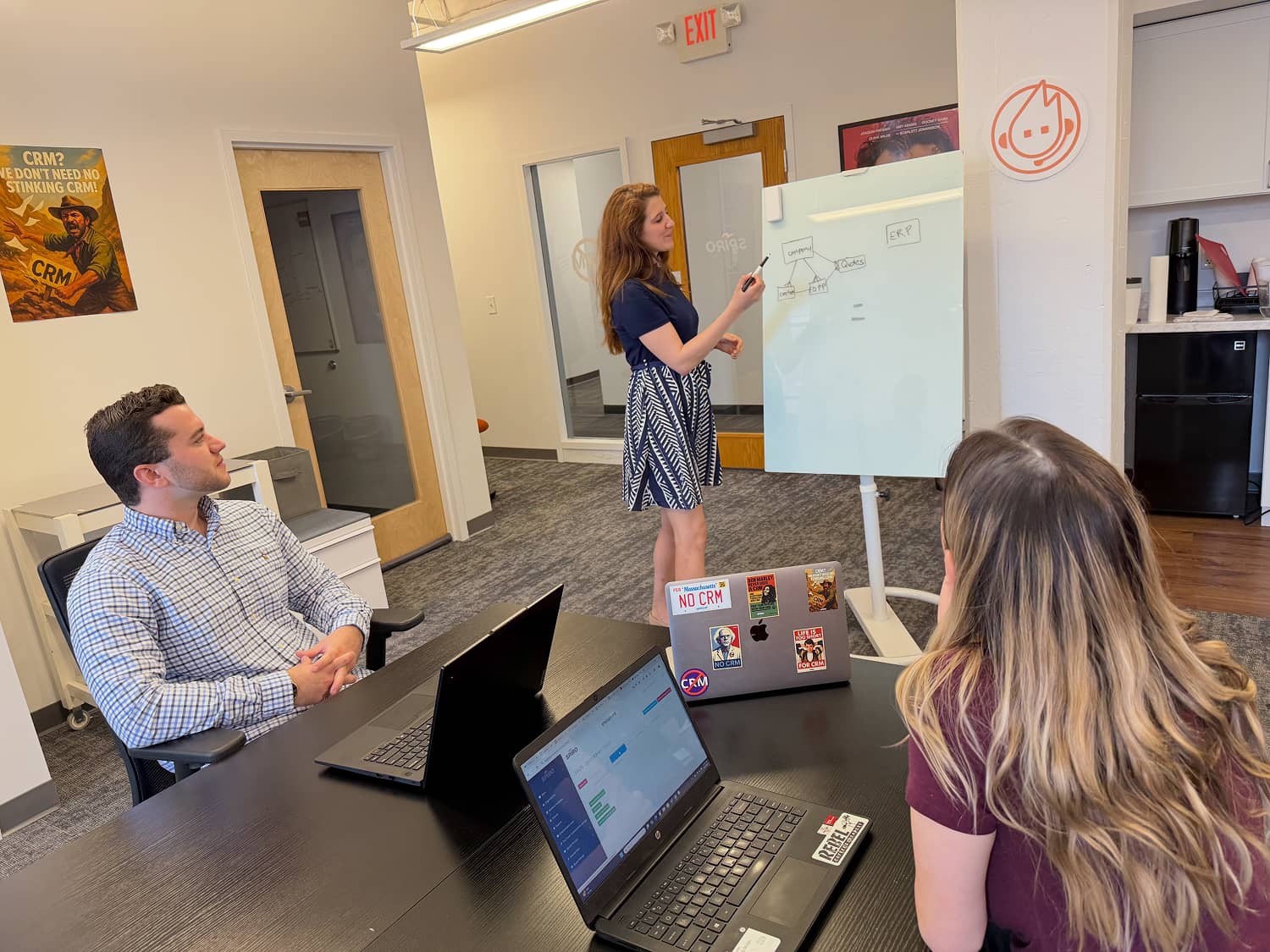 Spiro team members collaborating in-office on a manufacturing client’s CRM setup, reinforcing hands-on, in-house onboarding without third-party consultants.