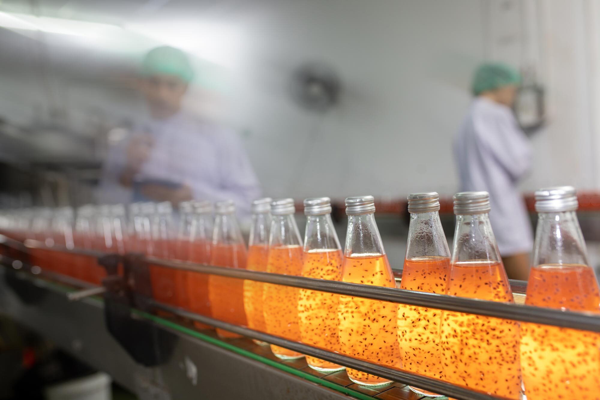 Bottles moving along a beverage packaging line
