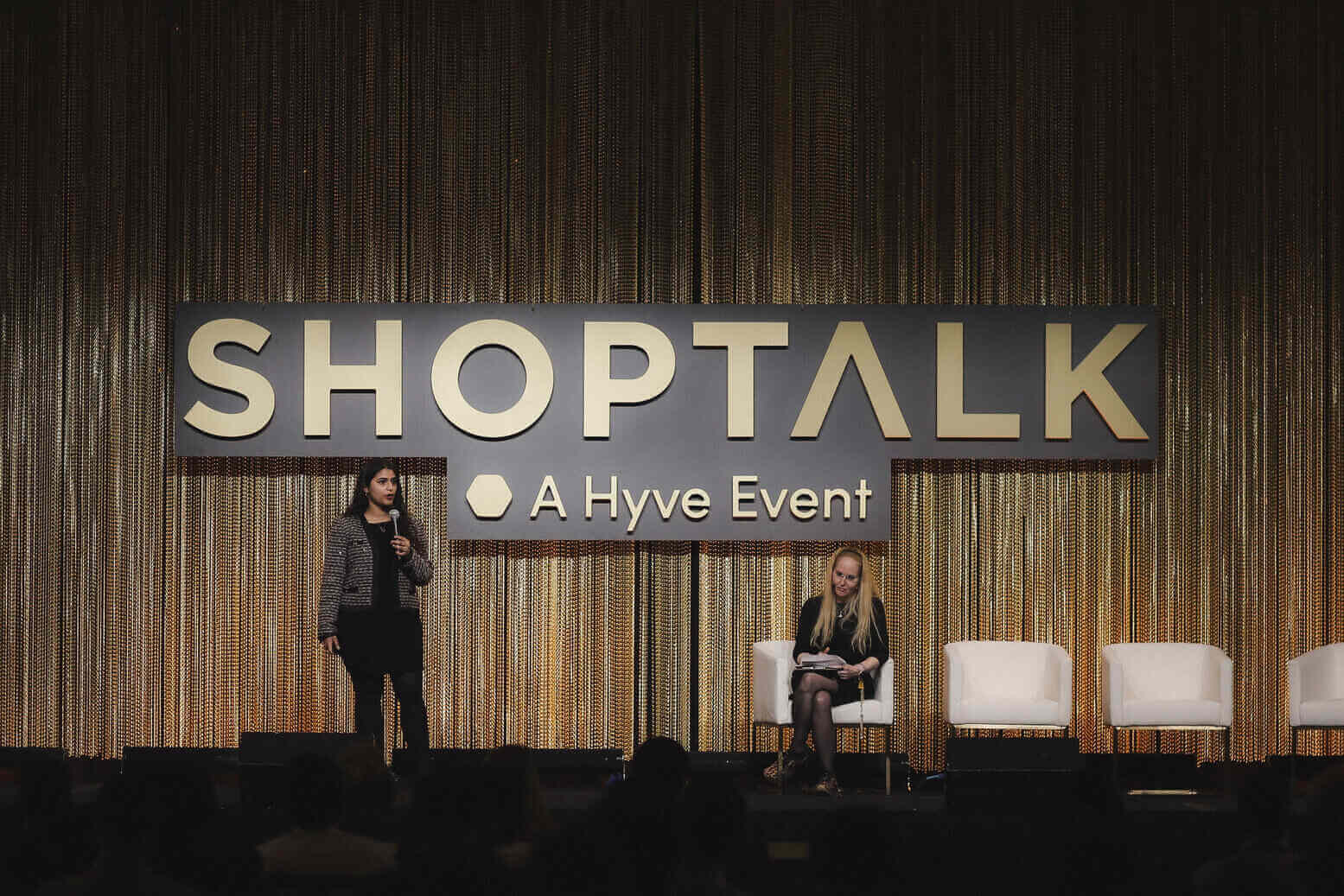 Amrita Bhasin speaking on stage at Shoptalk, a Hyve Event