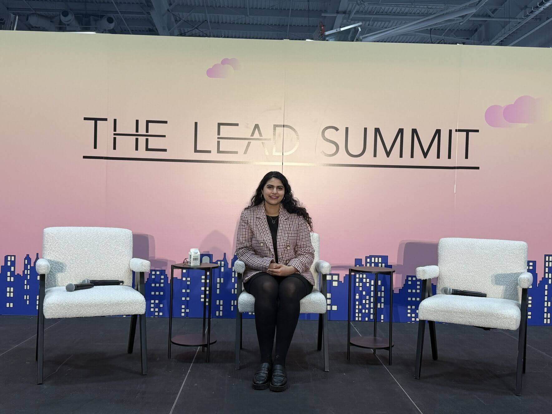 Amrita Bhasin seated on stage at The Lead Summit
