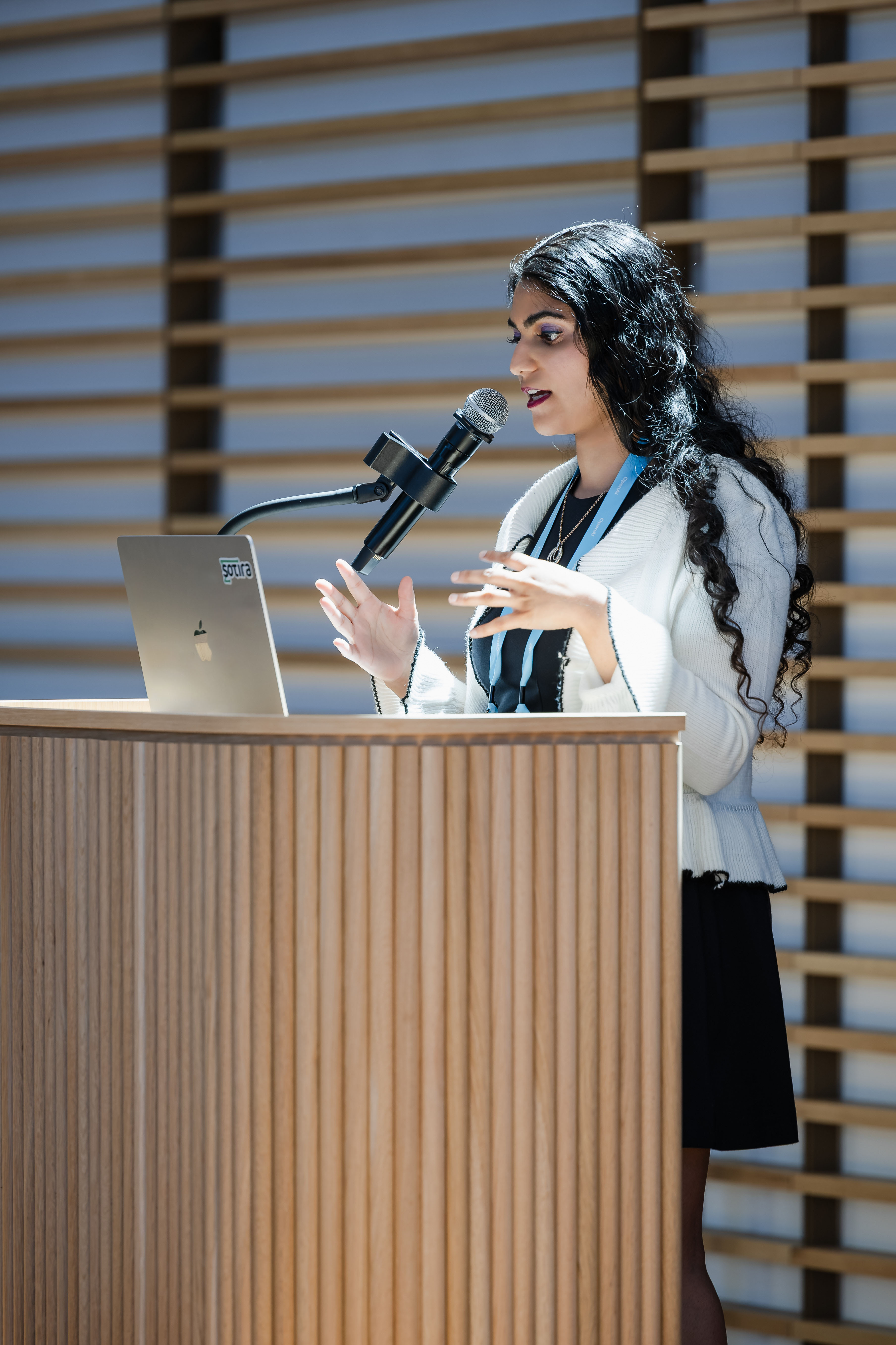 Close-up of Amrita Bhasin speaking at OpenAI