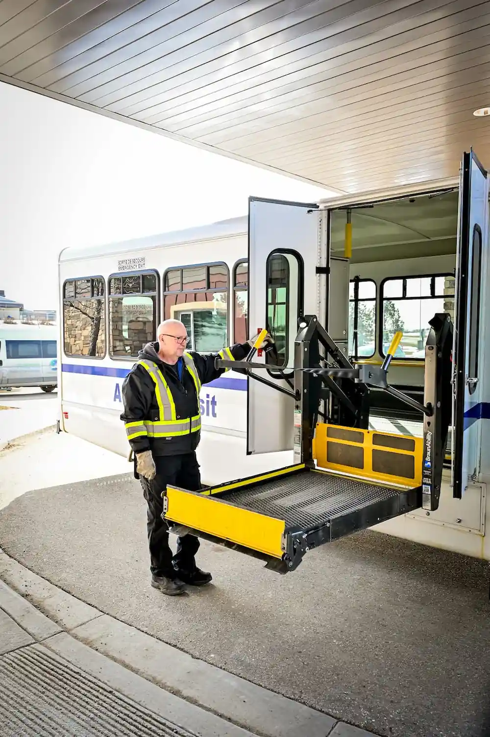 bus driver bringing access ramp down from bus