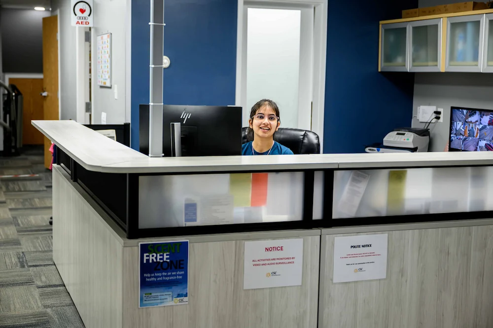 front desk admin member sitting at desk