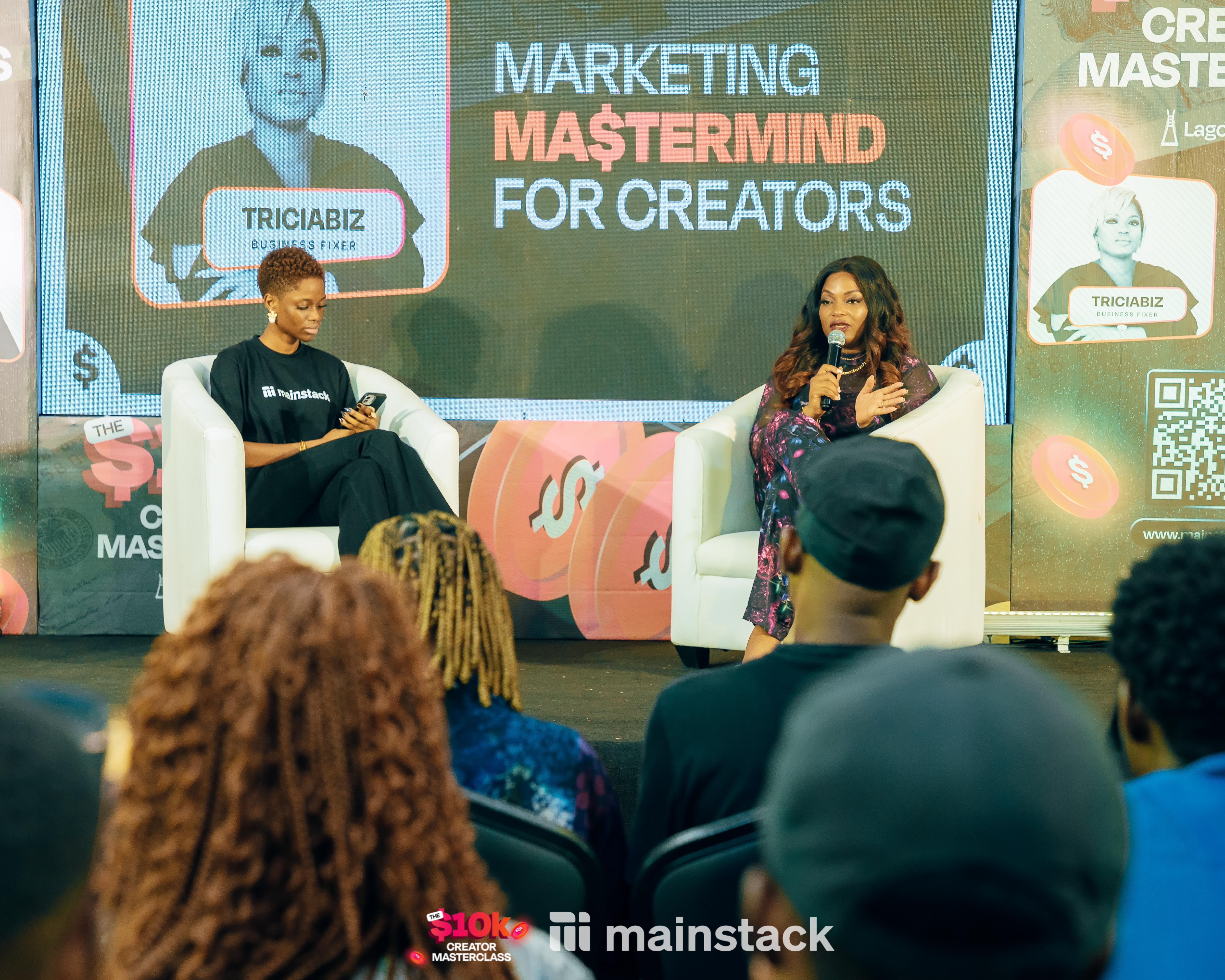 Grace Fasetire and Tricia Biz on stage at the fireside chat
