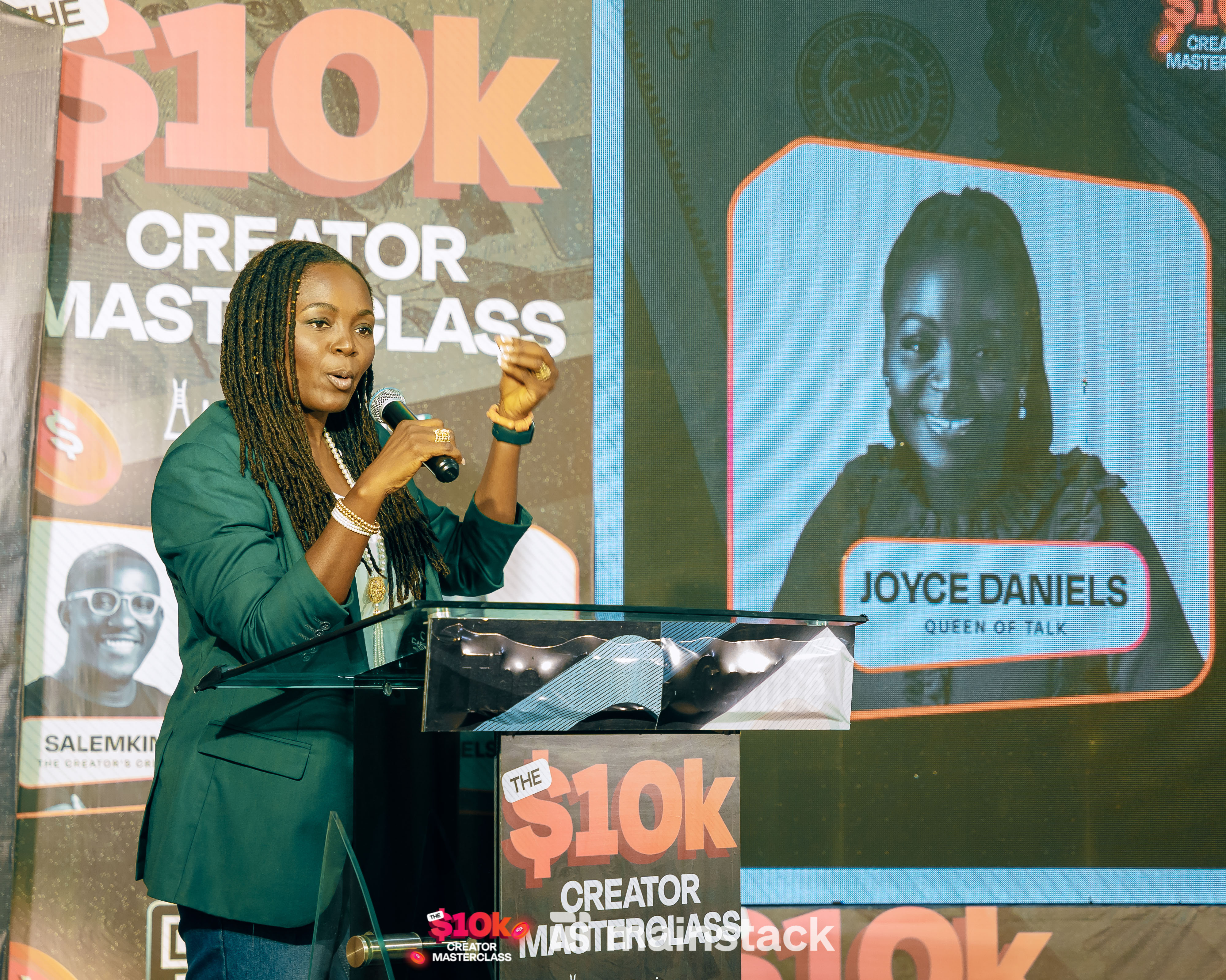 Joyce Daniels on stage addressing attendees at her session