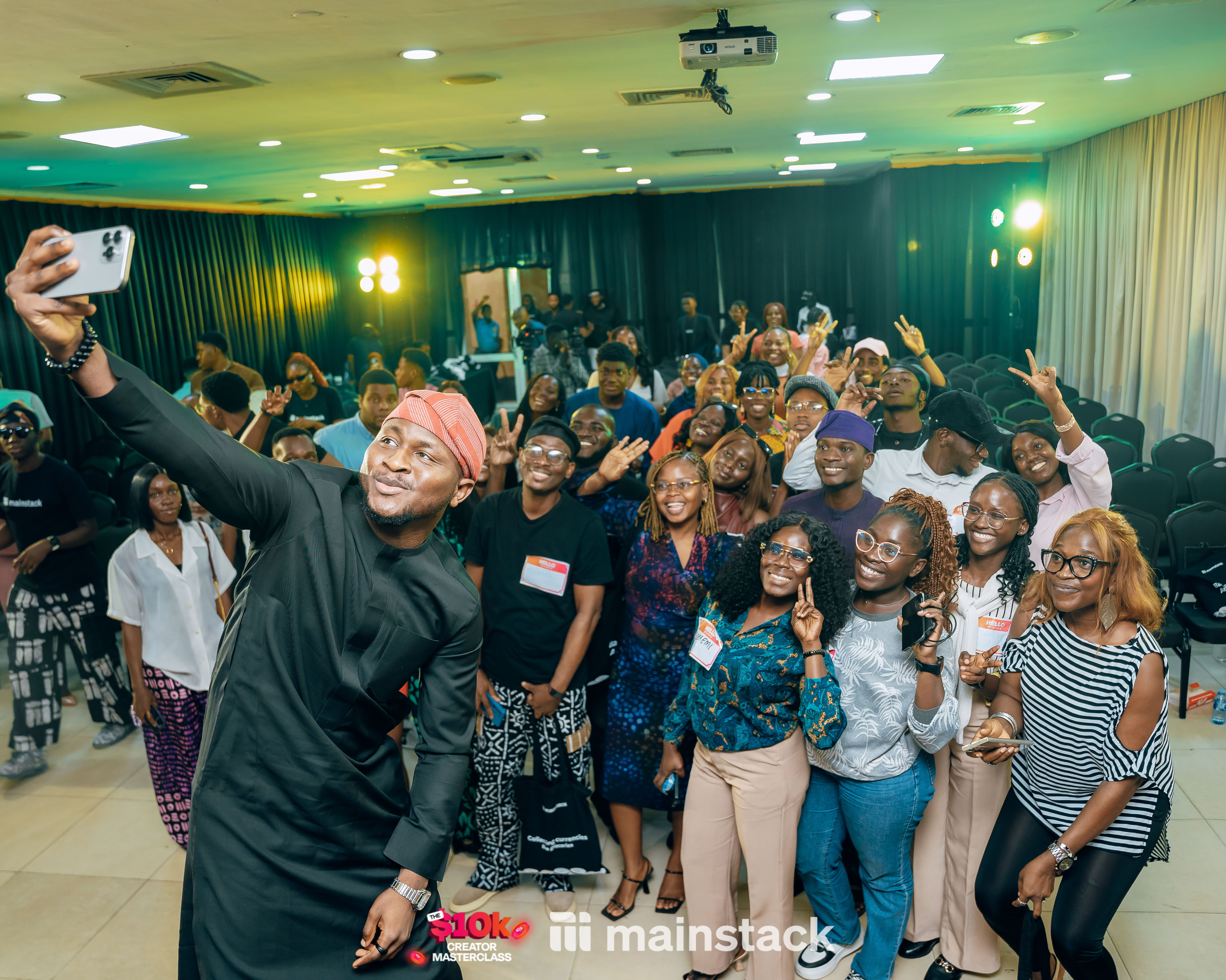 Mainstack's CEO and Co-Founder, Ayobami Oyaleke taking a selfie with some attendees at the 10k Creator Masterclass