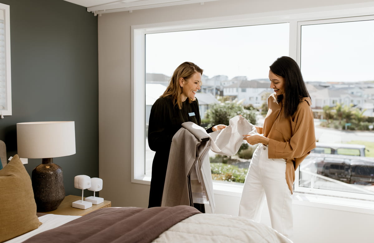 Lady choosing which curtains are best from the comfort of her home