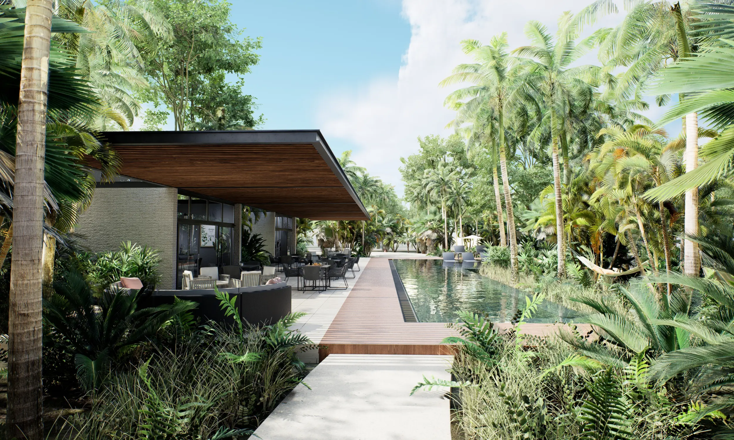 Modern outdoor patio with seating next to a long rectangular pool surrounded by tropical plants and palm trees.