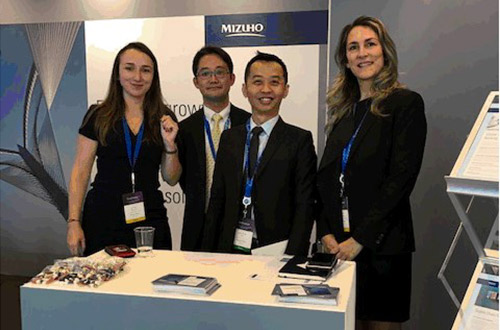 group of people standing behind a desk