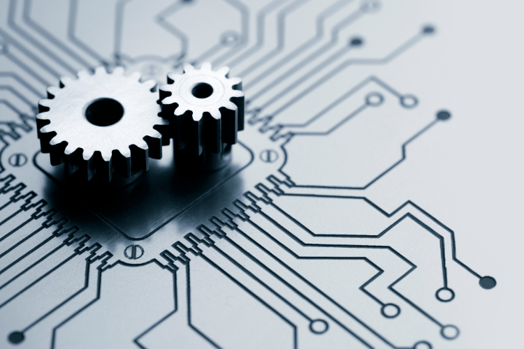 Two metal gears positioned on a printed circuit board pattern