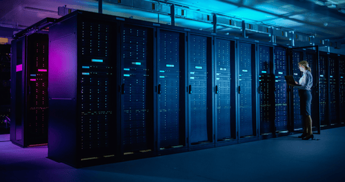 Rows of illuminated server racks in a modern data center