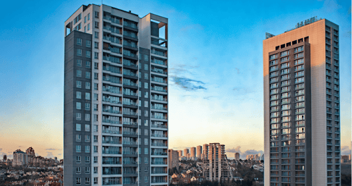 Tall residential towers under a blue and orange sunset sky


