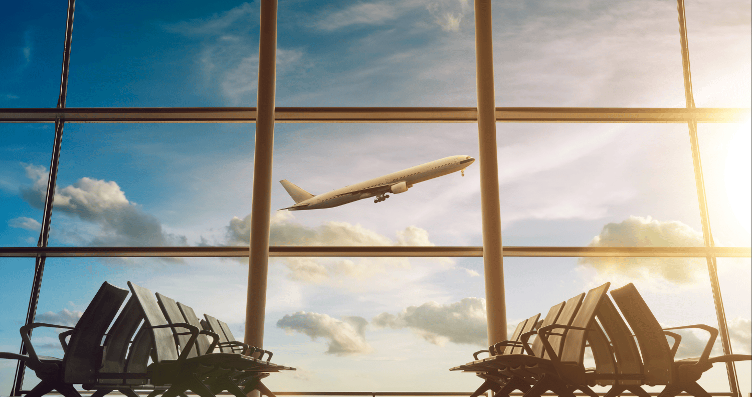 Airport terminal with aircraft in flight, illustrating complex transport and infrastructure delivery environments