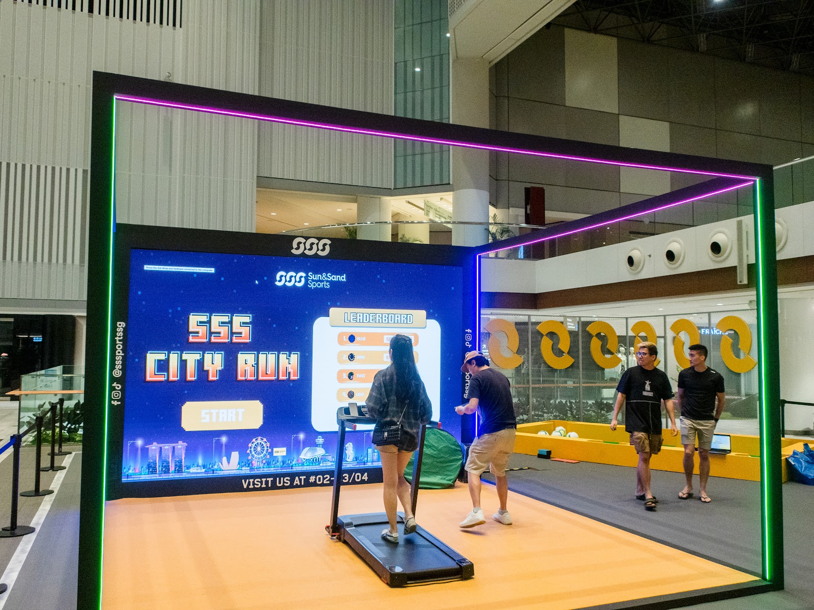 Runner on a treadmill controlling a virtual city course across a wrap-around interactive LED wall
