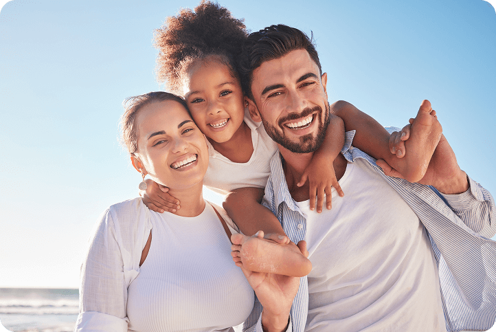 A smiling family enjoying time together at the beach, representing happy customers exploring LendingClub competitors.